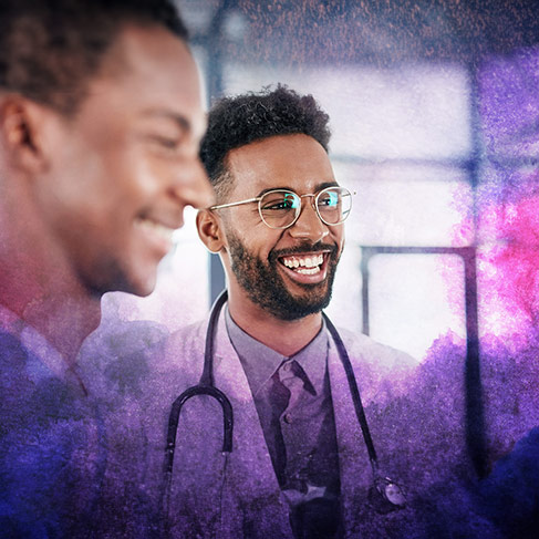 A male doctor laughing with patients